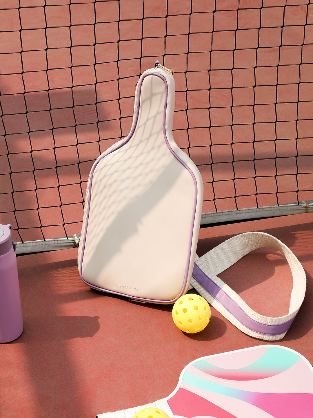Cream and lavender pickleball paddle sling bag for women with a dedicated front paddle pocket - Haute Sauce
